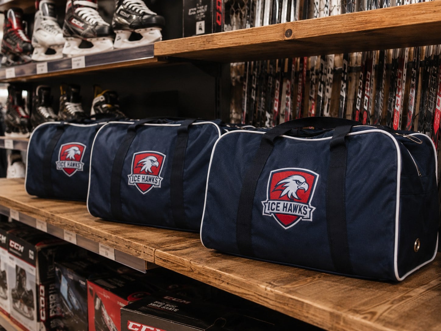 Custom hockey bags displayed for sale in a pro shop